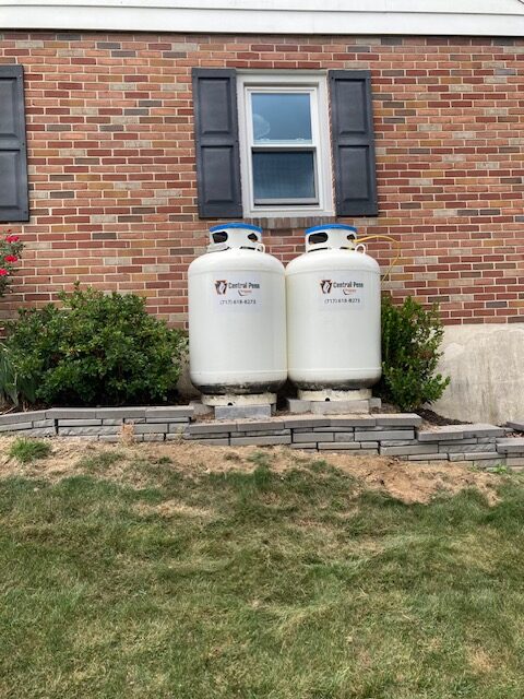 Two residential propane tanks installed and filled for home heating and energy needs, part of commercial propane services.