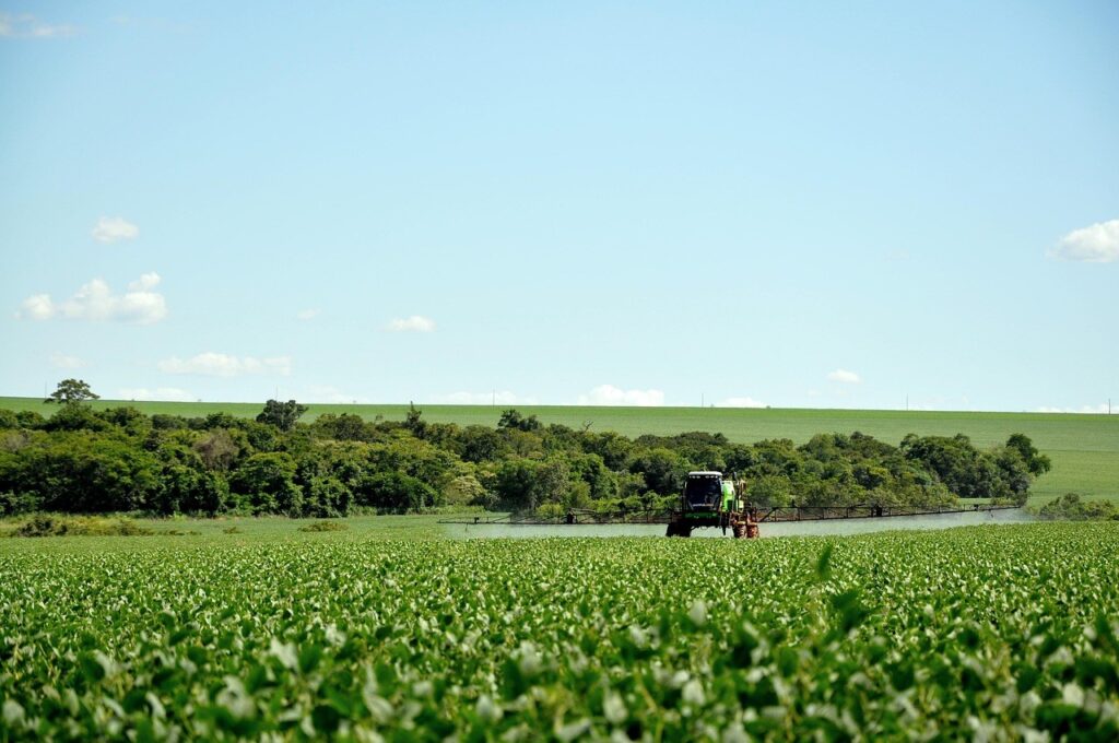 Propane-powered farm equipment operates in a wide agricultural field, demonstrating the efficiency of propane for farms, propane-powered equipment, and propane delivery and storage in action.
