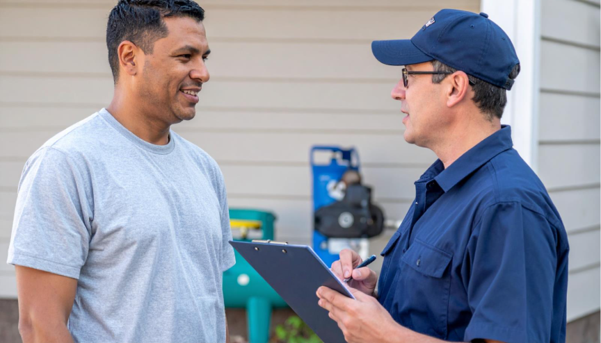 A technician discusses propane tank installation with a satisfied client, showing the checklist of installation and safety procedures.