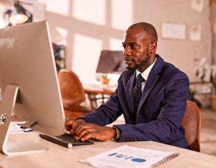 A businessman using a computer in Lancaster, PA to place an online order for bulk fuel delivery of off-road diesel and compliant dyed diesel.