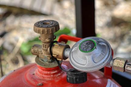 A close-up of a propane gauge and handle being inspected, demonstrating safe and reliable Residential propane, propane delivery, Central Penn Propane service.