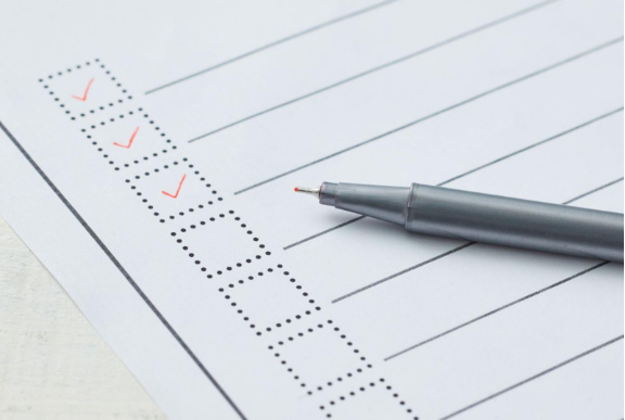 A pen resting on a winter propane checklist, illustrating propane safety tips and steps to properly maintain a propane tank for winter use.