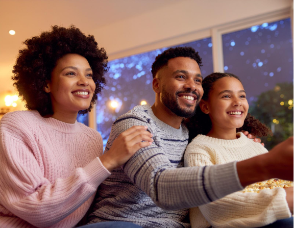 Family gathered in their living room, enjoying warmth made possible by a propane tank heating their home.