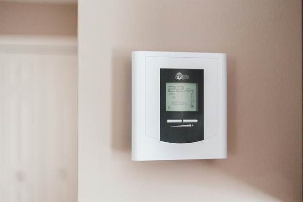 Modern thermostat being adjusted to improve heating efficiency with Central Penn Propane systems.