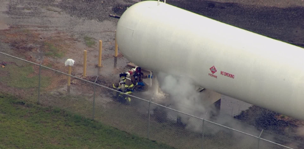 Commercial propane tank leaking while professionals repair it to ensure safety for Chester County businesses.
