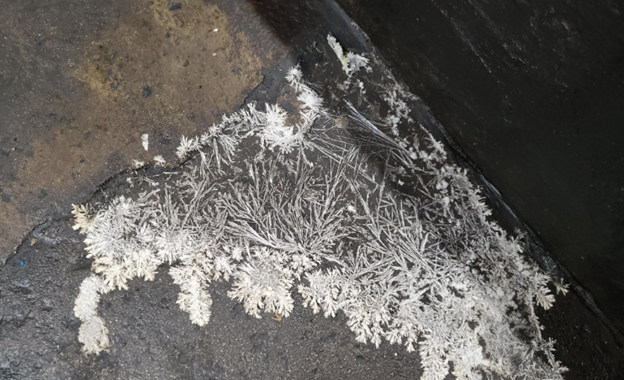Diesel fuel frozen in crystal state on a fuel tank, showing the importance of winter diesel equipment protection.